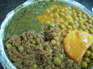 Lamb keema, aloo mattar and mustard greens.