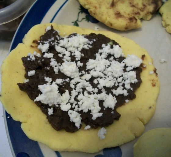 Pupusa bottom with beans and cheese